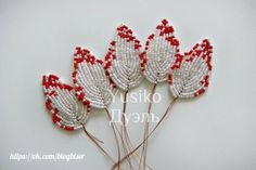 three red and white beaded flowers on top of each other