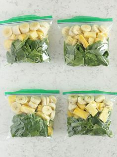 four bags filled with bananas and spinach on top of a white countertop next to each other