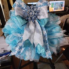 a large blue and white bow with snowflakes on it's center piece