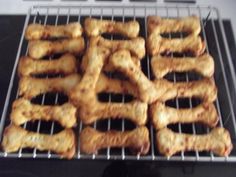 there are many dog bones on the rack in the oven, and they look like they're ready to be cooked