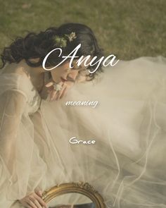 an image of a woman in a wedding dress looking into a mirror with the caption, anaya meaning grace