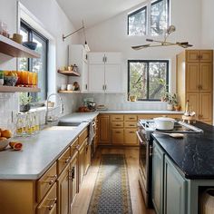 a kitchen filled with lots of counter top space next to a large open window on the wall