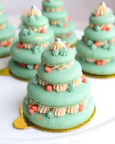 there are many green cupcakes on the white plate and one is decorated like a christmas tree