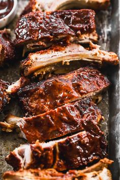 bbq ribs with barbecue sauce on the side, ready to be cooked in the oven