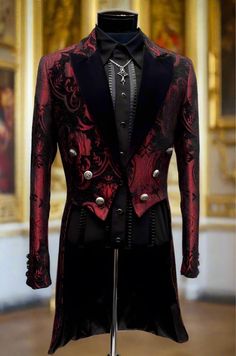 a red and black jacket on display in a museum setting with gold paintings behind it