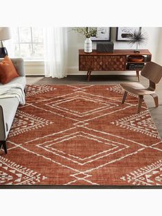 a living room with a couch, chair and rug