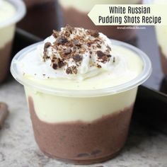 two dessert cups with white russian pudding and chocolate shavings on the top one is filled with whipped cream