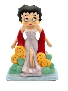 a figurine of a woman in a white dress