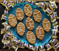 football cookies on a blue plate with foil wrapped around them