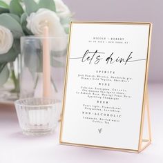 a table setting with a menu and candles