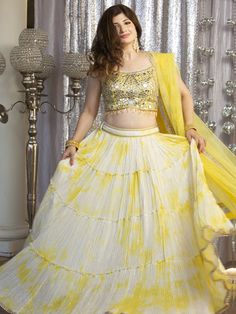 Go all out in this whimsical lehenga, studded with precious mirror, pearl, stone, embroidery work, which is sure to bring out the innate grace and grandeur in you! Color - Lemon Yellow Fabric & Work Style - - Silk blouse: mirror, pearl, stone, embroidery work. - Soft net lehenga: mirror, pearl, stone, embroidery work. - Soft net dupatta: embroidery work. Details - - Assured quality - Wash care instruction: Dry clean only. - Slight variation in color is possible due to digital photography.