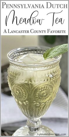 a glass filled with tea sitting on top of a table