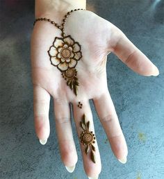 a woman's hand with hennap and flowers painted on the palm is shown