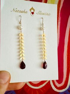 Long golden snakes earrings swing and sway and sparkle with every move. Great for a special occasion like Valentine's Day or even a wedding!  The earrings feature a gsparkly gold plated snake chain, white pearl and a gorgeous dark red garnet drop at the end. Gold Pearl Earrings With Ear Wire For Party, Yellow Gold Teardrop Pearl Earrings For Party, Gold Drop Pearl Earrings For Party, Golden Snake, Snake Earrings, Red Garnet, White Pearl, Snake Chain, Dark Red