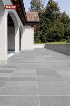 an empty building with grey tiles on the ground