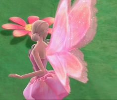 a pink fairy is standing next to a flower