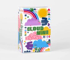 a box with the words cloud nine printed on it and rainbows, stars, clouds, sun, mountains