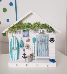 a white house with blue and green accents