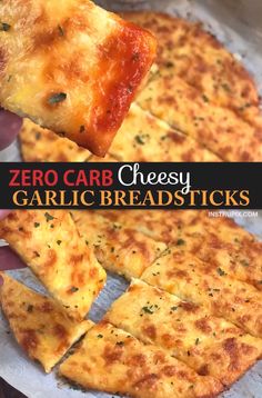 someone holding up a piece of cheesy garlic bread