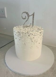 a white cake with silver numbers on it