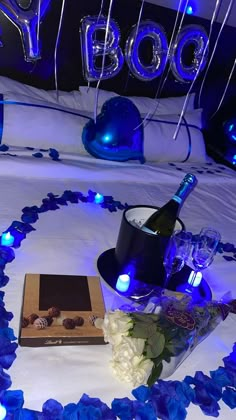 a bed with blue lights and decorations on it, including a bottle of booze