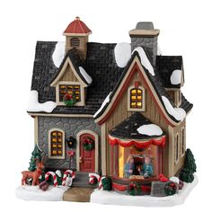 a small christmas house with lights and decorations