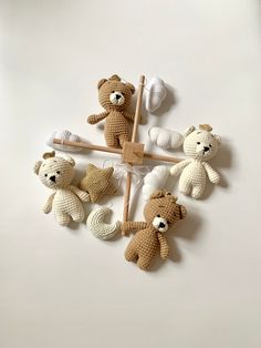 several crocheted teddy bears are arranged on a white surface, including one holding a toothbrush