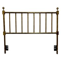 a metal headboard with two knobs on each side and an iron bar at the top