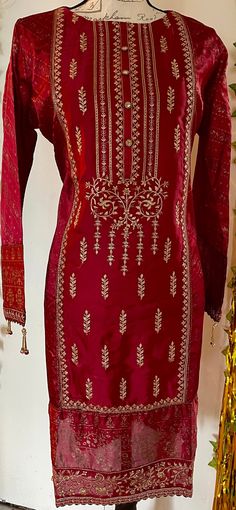 It is a beautiful ready to wear kurti for women. It is available in medium  size only. Chest 43 inches all around, waist 43, hips 46 and length 38 inches.  It is a beautiful embroided kurta with sequin work and block print on it. It is just a kurti no pants with this. It is bin Saeed branded kurti. Fabric silk. Color red. No return or exchange please. Red Cotton Silk Churidar With Straight Kurta, Navratri Silk Kurta For Designer Wear, Navratri Designer Silk Kurta, Silk Kurta With Resham Embroidery Tunic, Silk Tunic Kurta With Resham Embroidery, Silk Resham Embroidery Tunic Kurta, Silk Resham Embroidery Kurta Tunic, Festive Zari Work Tunic Set, Silk Churidar For Navratri