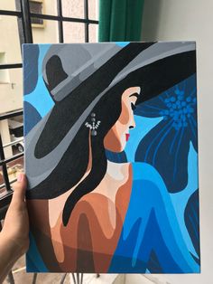 a painting of a woman wearing a black hat and blue dress is being held up by someone's hand