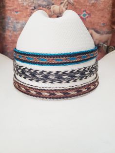 Wide Braided Horsehair Adjustable Hat Band with 2 sliding knots that make this hatband a great fit for most hats. - Available in 3 colors:  Turquoise Blue/Brown/Tan, Tan/Brown/White, OR Black/White/Grey - This stunning hat band is made from genuine braided horse hair and will compliment your favorite cowboy hat.   - 5 braided strands are sewn together to create this gorgeous hatband. - Hat band measurements: approximately adjusts to 27" around and is 3/4 inch wide - Hat bands are shown on a size 7 hat.  Hats are not included. - See my other HORSE HAIR hat bands:  https://www.etsy.com/shop/BlueEyesDesignsHB?ref=shop-header-name&listing_id=1296906619&from_page=listing&section_id=50325232 - See my LEATHER hat bands:  https://www.etsy.com/shop/BlueEyesDesignsHB?ref=shop-header-name&listing_id= Adjustable White Southwestern Hat, White Southwestern Adjustable Hat, Adjustable Brown Western Mini Hats, Southwestern White Adjustable Hat, Adjustable Brown Mini Hat For Rodeo, Adjustable Brown Mini Hats For Western-themed Events, Adjustable Turquoise Hat Bands For Country Events, Adjustable Southwestern Turquoise Hat Bands, Adjustable Multicolor Hat For Western-themed Events