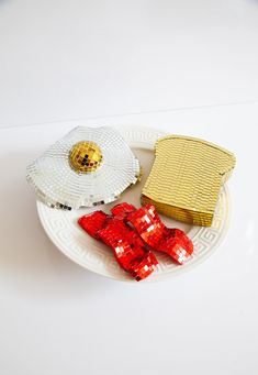 a plate that has some food on it and is decorated with red sequins