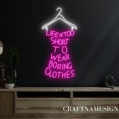 a neon sign that says life's too short to wear boring clothes on it