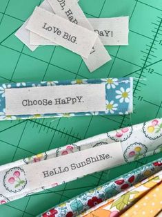 several different types of sewing rulers on a cutting board with words that read choose happy