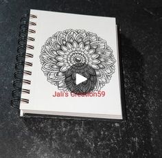 a spiral notebook with an image of a flower on it