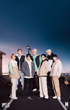 an image of group of people standing in the parking lot with sky background and clouds