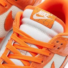 An icon in its own right in both the streetwear and skate spheres, Peter Moore’s legendary Nike Dunk low-tops now take on a vibrantly fresh perspective with this cracked orange pair. Here, the sportswear giant expertly experiments with texture; using a glossy patina across the tumbled leather uppers along the overlays - contrasted by a cracked effect across the signature sidewall Swooshes. It’s all complemented by the semi-translucent orange outsole that keeps the statement going, even underfoot Nike Low Tops, Fresh Perspective, Dunks Nike, Casual Sneakers Women, Nike Dunk Low, Low Sneakers, Sneaker Collection, Dunk Low, Sportswear Women