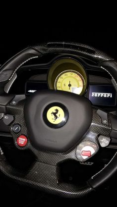 the interior of a car with steering wheel and gauges