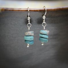 "These lovely blue earrings will become everyday favorites.   Each earring has three beads of Leland Blue in varying shades that gently swing from a sterling silver ear wire.   Leland blue is a glass-like byproduct of the iron industry in Northern Michigan.  Well over 100 years ago this byproduct, called slag, was discarded in Lake Michigan.  It has been washing up on shore ever since, especially near its namesake town of Leland, MI.  Jewelers and rockhounds have been collecting and using this \ Everyday Blue Earrings With Natural Stones, Minimalist Blue Wire Wrapped Earrings, Leland Blue Stone, Blue Stone Pendant, Beads Craft Jewelry, Beads Craft, Blue Dangle Earrings, Craft Jewelry, 100 Years Ago