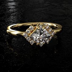 a gold ring with a princess cut diamond surrounded by smaller round brilliant diamonds on a black surface