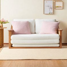 a white couch sitting on top of a wooden floor