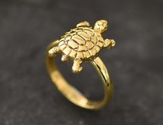 Dainty Gold Turtle Ring made of Gold Vermeil: 18k Gold over Solid 925 Sterling Silver ☞ made to last.Click here for ☞ Matching PendantClick here for ☞ Matching Earrings Details:• Gold Turtle Ring• Band width ≈ 2.1mm, thickness ≈ 1mm• 18K Gold Vermeil SKU 1626 Tortoise Ring, Ocean Ring, Turtle Ring, Animal Ring, Gold Flower Ring, Turtle Jewelry, Emerald Ring Gold, Animal Rings, Plated Ring