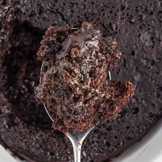 a spoon full of chocolate cake in a bowl