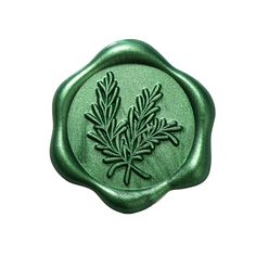 a wax stamp with a green plant on it's center and leaves in the middle