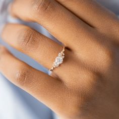 a woman's hand with a diamond ring on it