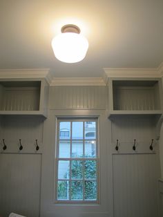 an empty room with white walls and cabinets