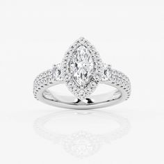 a white gold ring with an oval cut diamond and two rows of diamonds on the band