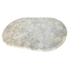 an oval marble tray with white and gray circles on it, against a white background