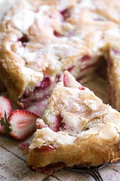 a close up of a pie with strawberries on it