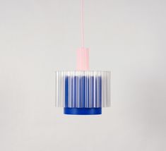 a blue and white light hanging from a ceiling fixture with a pink cord attached to it